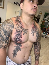 a man with a tattoo on his chest