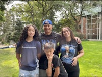 a family posing for a picture in front of a building